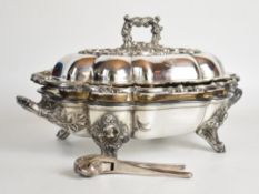 Ornate silver plated covered warmed entrée dish and novelty silver plated Asprey nutcracker formed