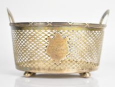 American silver twin handled basket with pierced decoration, raised on four bun feet, marked