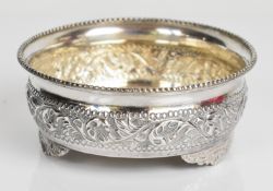 Eastern silver wine coaster or shallow bowl with embossed decoration, beaded rim and raised on three