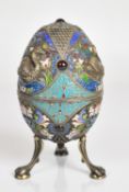 Pavel Ovchinnikov Russian silver and cloisonné enamel egg, decorated with swans and raised on claw