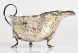 Mappin & Webb George V hallmarked silver sauce boat with wavy edge, scroll handle and raised on