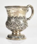 Continental silver mug or cup with scroll handle and embossed floral decoration, with indistinct