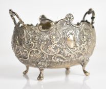 Continental silver twin handled sugar or similar bowl with embossed decoration and raised on four