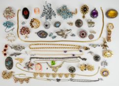 A collection of vintage brooches including Sphinx, Trifari, silver RAF set with marcasite, Art