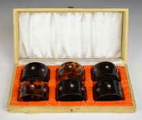 Cased set of six faux tortoiseshell napkin rings with jewelled decoration