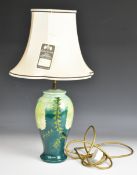Moorcroft table lamp decorated in the Banksia pattern, with original label to the silk shade