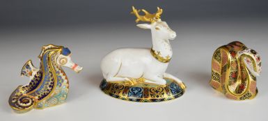Three Royal Crown Derby paperweights comprising Coral Seahorse with certificate, The White Hart