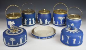 Five Wedgwood blue Jasperware biscuit barrels with classical decoration and plated mounts, an