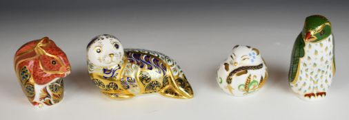 Four Royal Crown Derby paperweights comprising Harbour Seal, Harrods limited edition Rockhopper