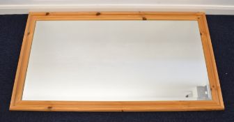 Pine framed bevelled glass mirror, 135 x 73cm