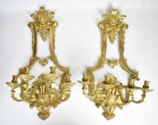 A pair of ornate brass four sconce wall mounted candelabra, H68 x W42cm