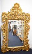 Large Regency style bevelled glass mirror with mask and shell finial, W118 x H208cm
