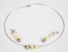 An 18ct white gold necklace with three cultured pearl beads (9.5mm diameter) with matching
