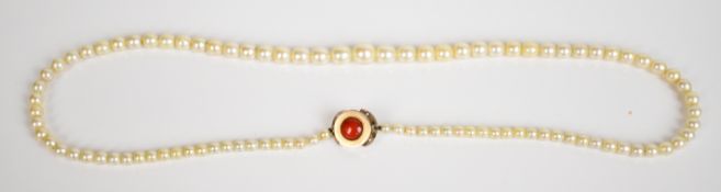 A single strand of cultured pearls, the 9ct gold clasp set with carnelian agate cabochon, the pearls