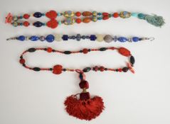 Three Eleyne Williams beaded necklaces, the first made up of carved cinnabar beads and Buddhas,