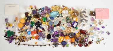 A collection of loose gemstones including pearls, lapis lazuli, mystic topaz, moonstone, amethyst,