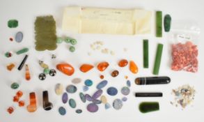 A collection of loose gemstones including black opal doublets, white opals, nephrite jade plaques,