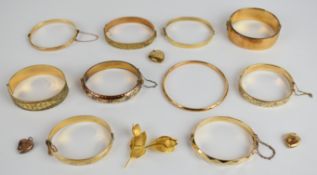 Ten gold plated bangles, one by L & Co, a rolled gold brooch and three heart shaped 9ct back and