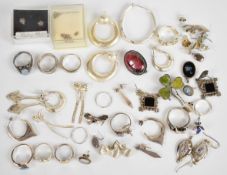 A collection of silver jewellery including shamrock brooch set with Connemara marble, eighteen pairs
