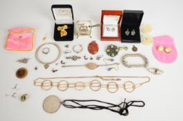 A collection of silver jewellery including earrings set with diamonds, two 'medic alert bracelet',