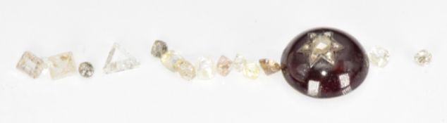 Fifteen loose diamonds including one trigon cut and some uncut examples, 4.9ct, and a garnet