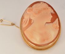 A 9ct gold brooch set with a cameo of a young woman, 23.6g, 6.2 x 4.6cm