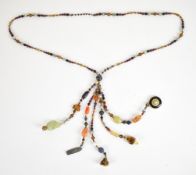 A beaded agate necklace made up of moss agate, smoky quartz, carnelian agate, jadeite, tiger's