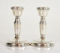 Pair of Elizabeth II hallmarked silver candlesticks, Birmingham 1965, maker W I Broadway & Co,