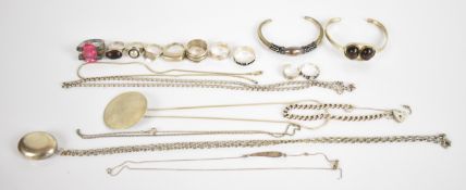 A collection of silver jewellery including eleven rings, two bangles, hammered pendant, curb link
