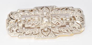 An 18ct gold brooch set with three diamonds in a platinum finished setting, 11.6g, 4.8cm