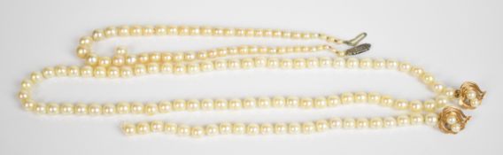 Two strands of cultured pearls, one with two yellow metal clips (needs restringing) and one with a