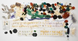 A collection of plaques and cabochons including malachite, onyx, carnelian agate, dendric agate,