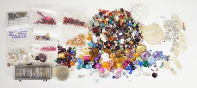 A collection of loose gemstones including heart cut amethyst, rubies, sapphires, citrines, smoky