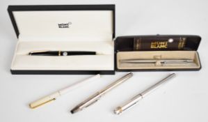 Five pens comprising two Montblanc fountain pens, Montblanc ballpoint pen, Must de Cartier