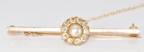 A 9ct gold brooch set with a split pearl surrounded by diamonds and one replacement synesthetic