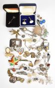 A collection of silver jewellery including eleven brooches, five pairs of cufflinks, two stick pins,