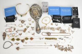 A collection of silver jewellery including nine pairs of earrings, two charm bracelets, locket,