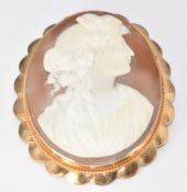 A 9ct gold brooch set with a cameo depicting a young woman, 14.2g, 4.6 x 5.2cm