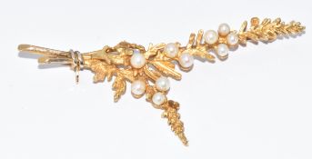 A 9ct gold brooch in the form of foliage set with pearls, 6.2g, 6.2cm