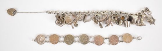 A silver charm bracelet with fourteen charms including dog, magician's hat, car, etc and a silver