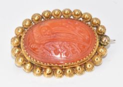 Yellow metal brooch set with carved carnelian agate (tests as 18ct gold) 5.4g, 2.6cm
