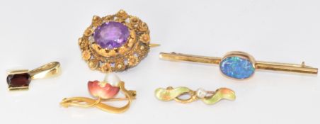 A 14k gold pendant set with an oval cut garnet (2.3g), two Edwardian brooches set with enamel and
