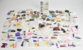 A collection of loose gemstones and beads including amethyst, tourmaline, agate discs, sapphire,