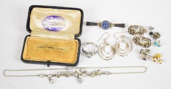 A collection of jewellery including moonstone necklace, silver brooch set with blue agate,