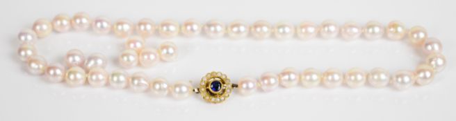 A single strand of cultured pearls with yellow metal clasp (tests as 14k gold) set with a round