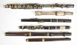 A group of wooden and metal flute and piccolo parts.