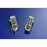 A pair of 18ct white gold earrings each set with a round brilliant cut diamond of approximately 0.