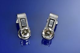 A pair of 18ct white gold earrings each set with a 0.9ct round brilliant cut diamond and a