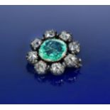 An early Victorian brooch set with a cushion cut emerald of approximately 4.2ct surrounded by