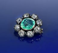 An early Victorian brooch set with a cushion cut emerald of approximately 4.2ct surrounded by